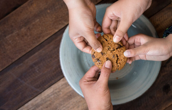 sharing concept – family sharing cookies